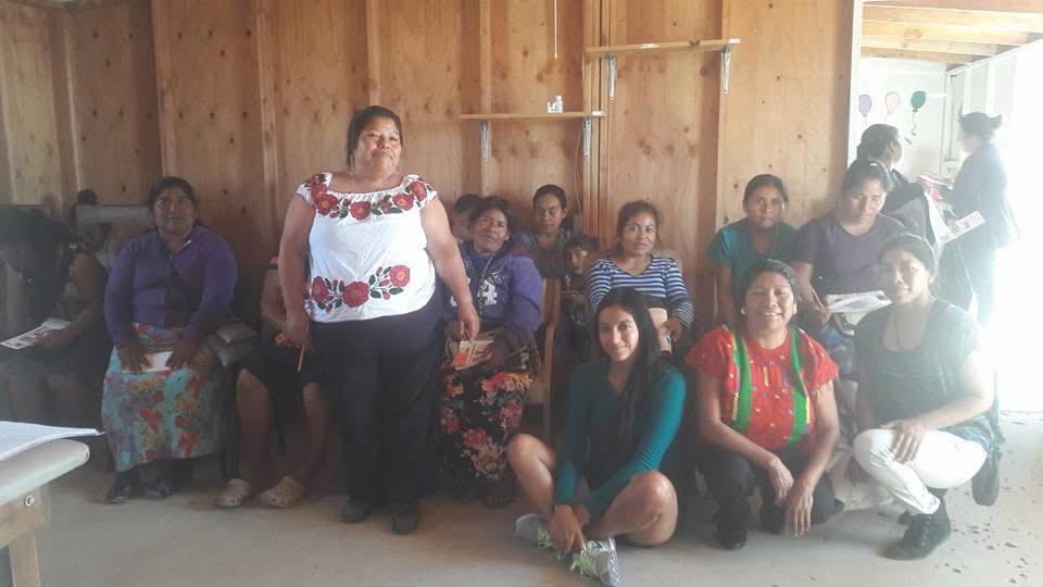 Taller comunitario con mujeres de comunidades originarias en una construcción de madera.